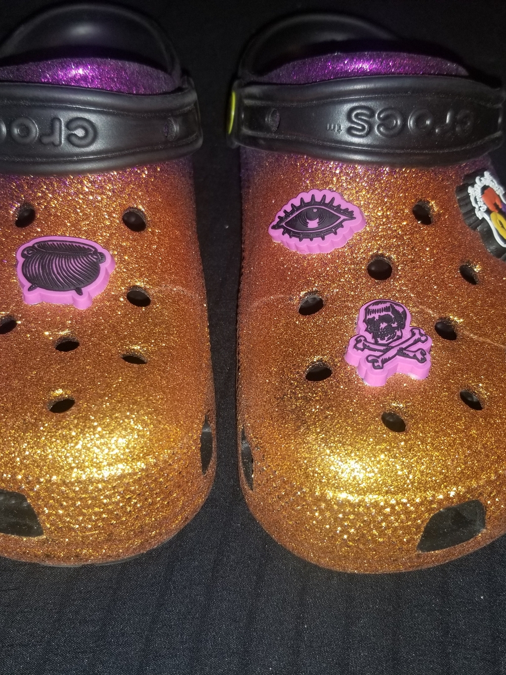 CROCS Kids' Glitter Clog in Orange with Black Strap and Pink Charms